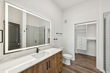 A bathroom with a white sink and a white toilet.